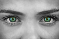 BW photo of woman with colorized green eyes
