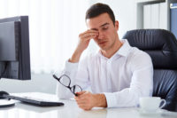Man Rubbing His Eye